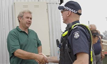 Dairy farmer and CFA volunteer Grant Ward with Victoria Police officer