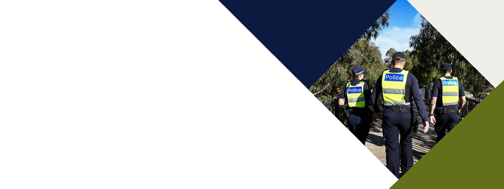 Decorative banner image of three police officers walking wearing police vests. 