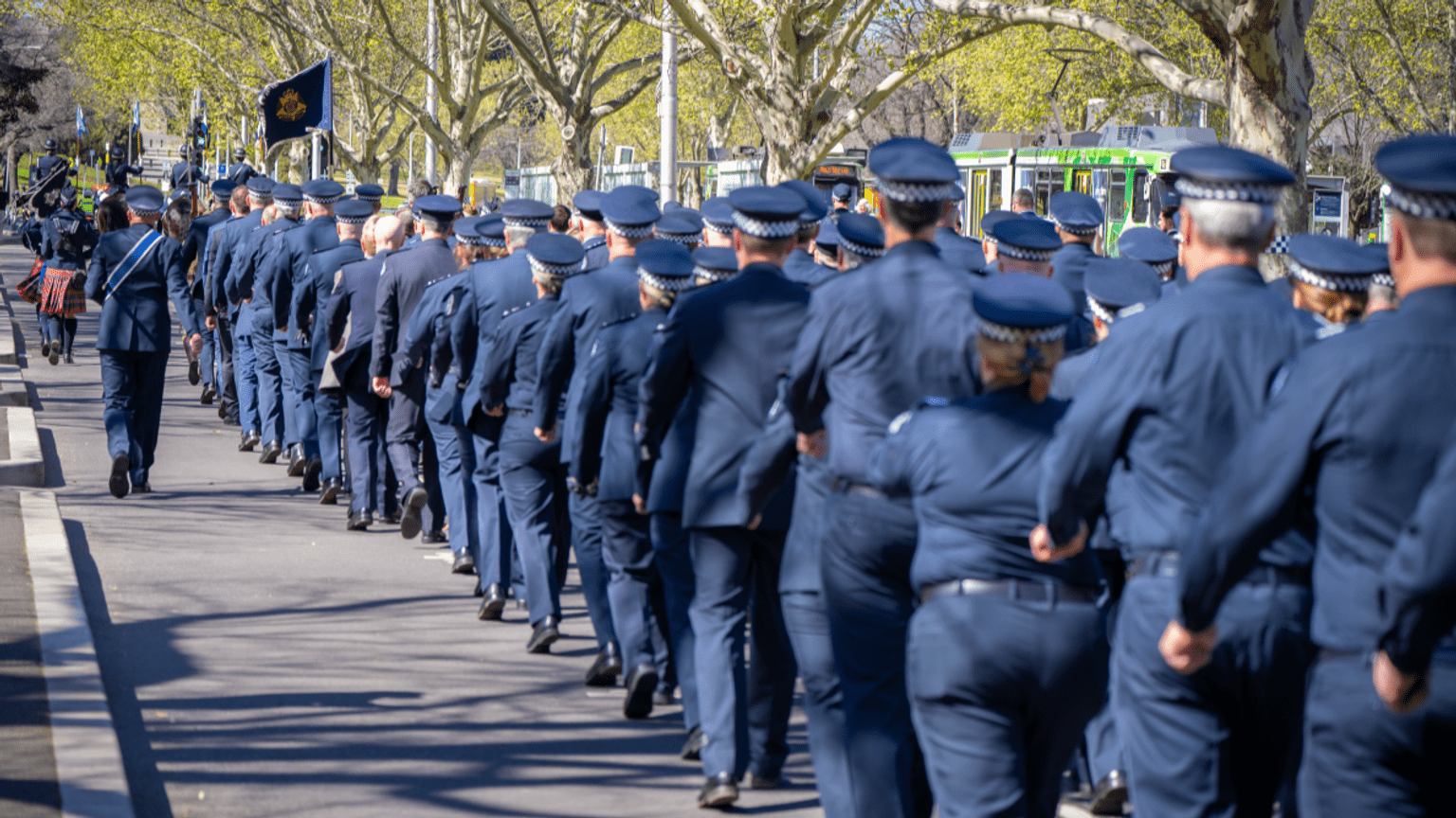 Victoria Police Officers wearing their formal blue uniform, march in procession to the Police Memorial. 